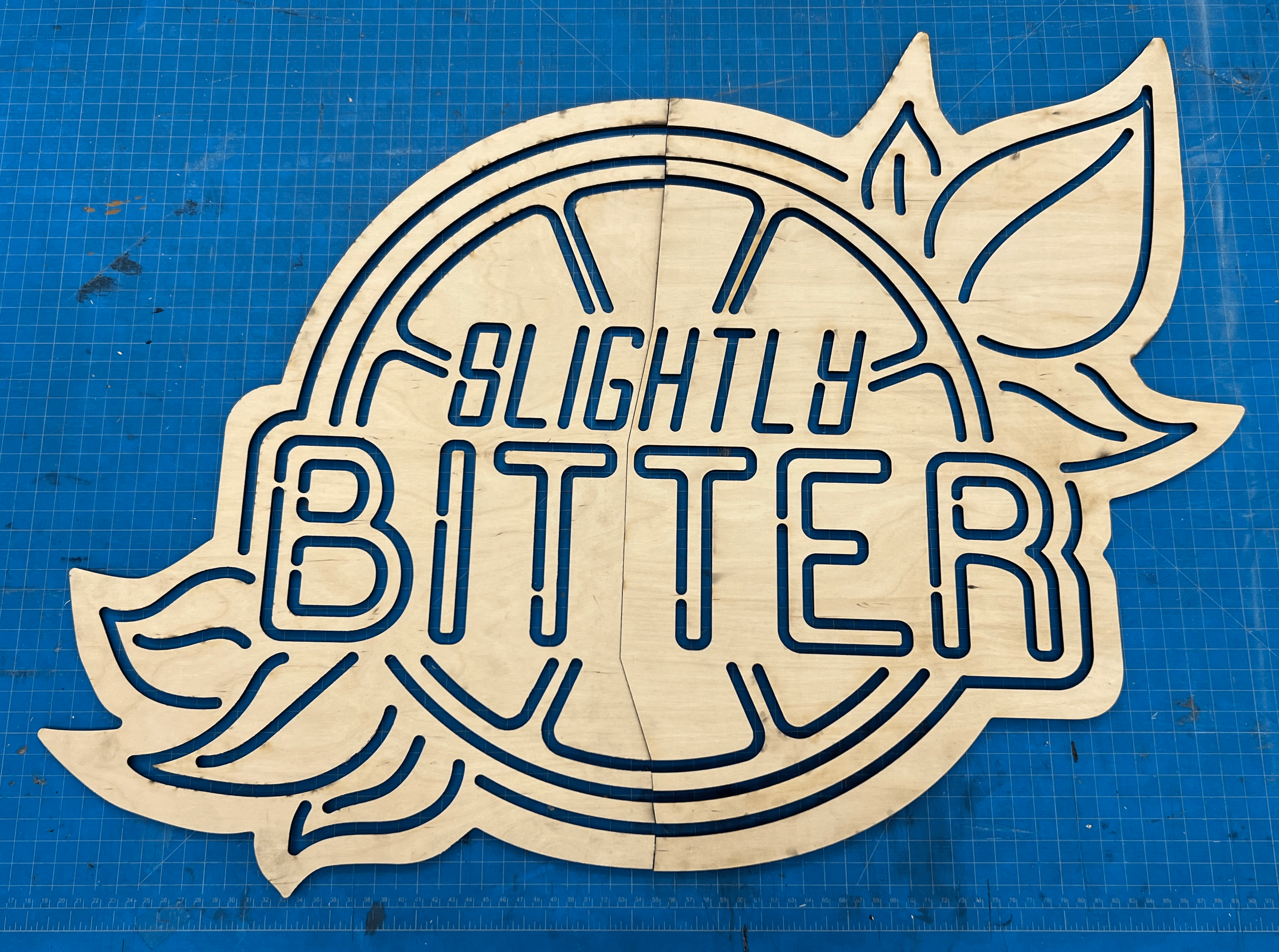 Photo of the wooden sign after being laser cut