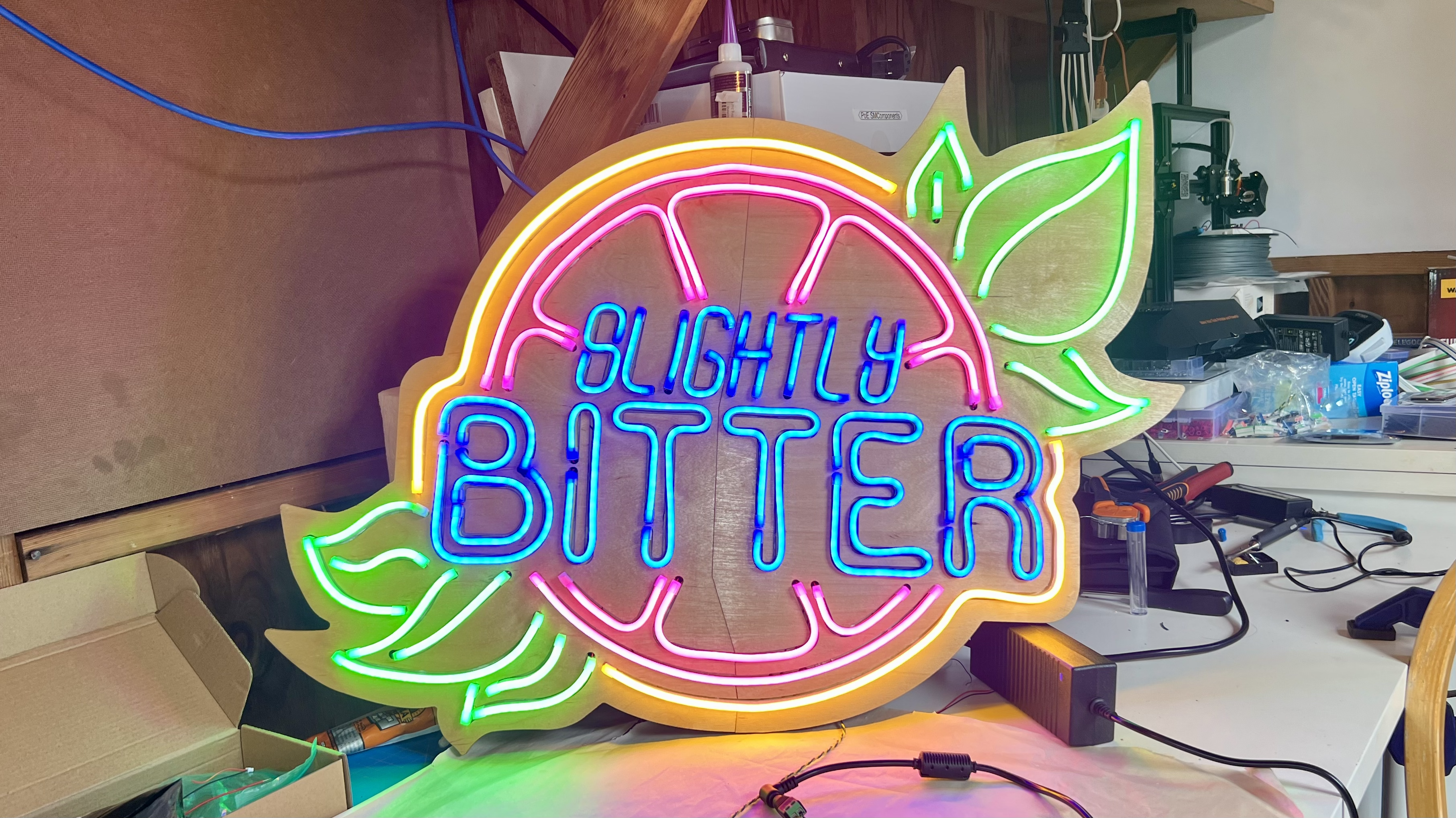 Final LED sign assembled. Sign is a grapefruit with the words "Slightly Bitter" written through the center