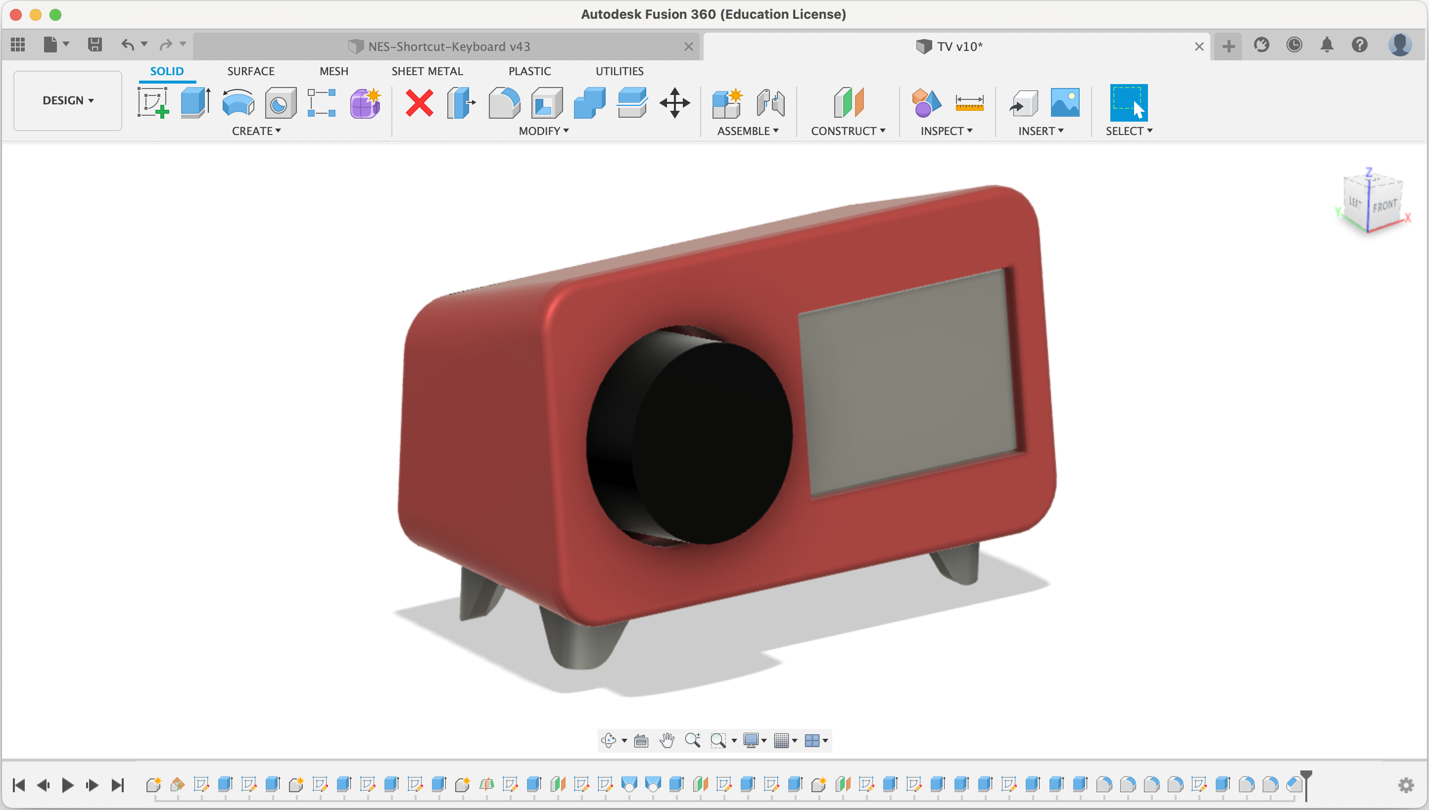 3d model of the retro TV case containing the OLED screen, rotary encoder, and switch. TV case is red, and the front face has the OLED screen and a large black knob, which is connected to the rotary encoder.
