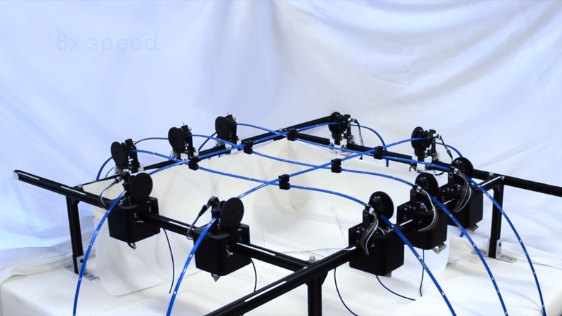 Timelapse of robotic gridshell moving between curved surfaces.