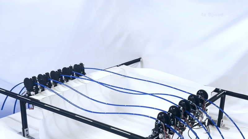 Timelapse of robotic gridshell moving between curved surfaces.